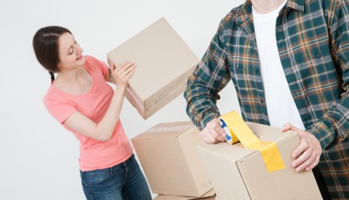Commercial office relocation process with labelled boxes and furniture dismantling